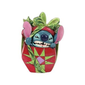 Figurine Stitch déchirant son cadeau de Noël